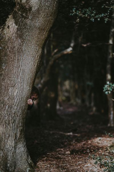 hiding behind tree